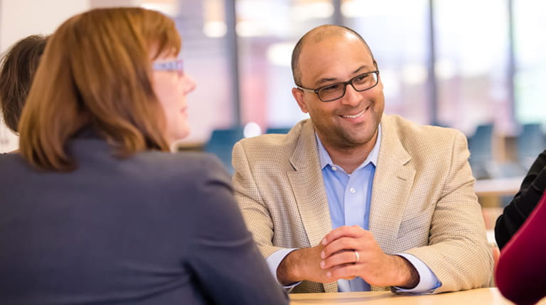 Employees talking at a table