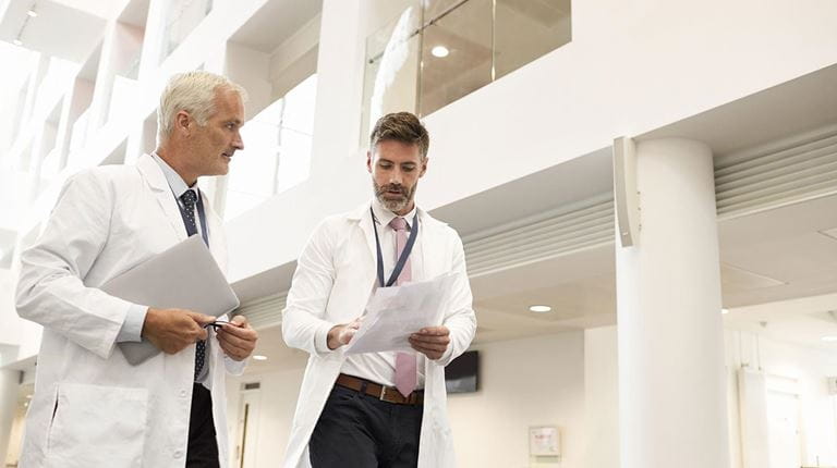 Two doctors walking in a hallway